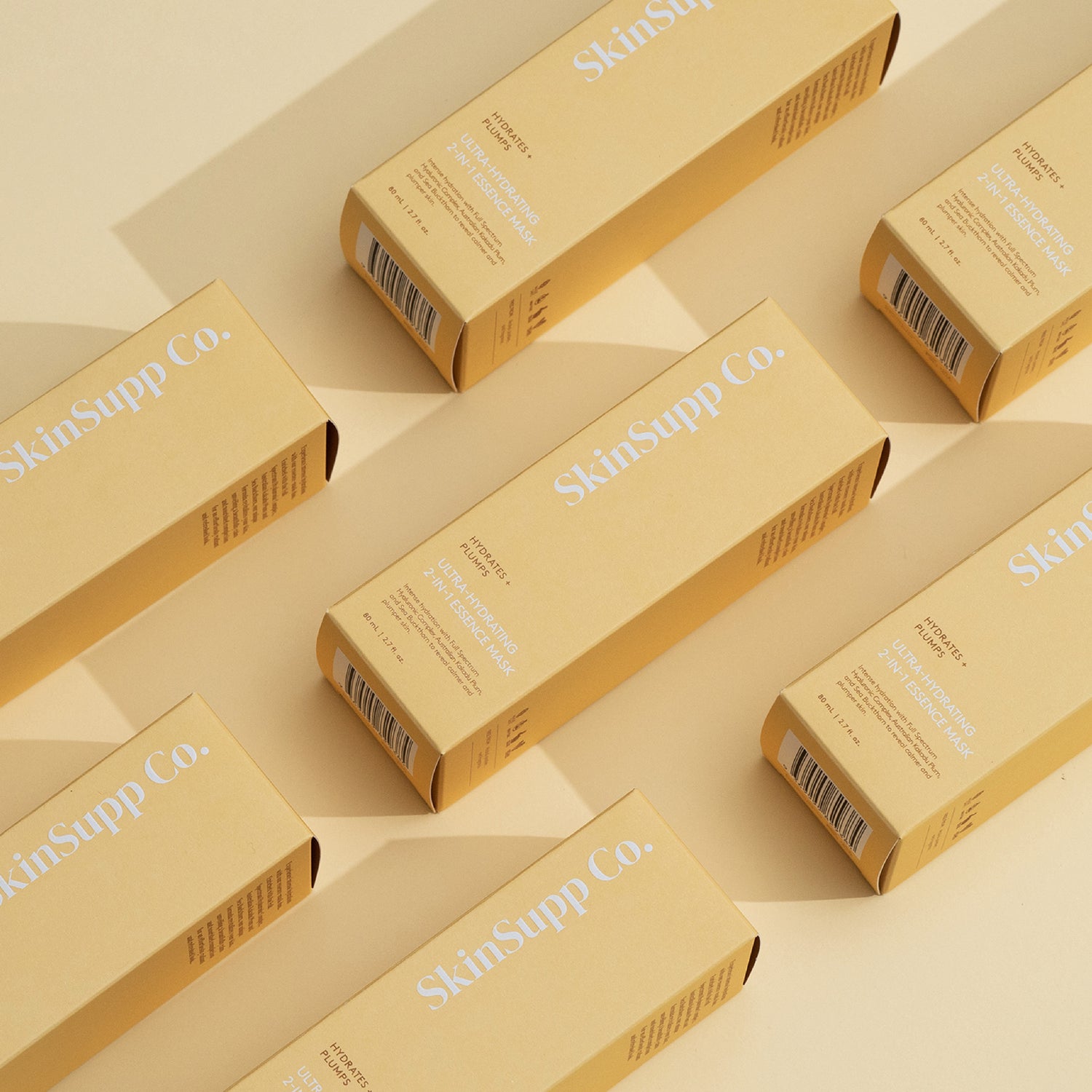 SkinSupp Co. Ultra Hydrating 2-in-1 Essence in Yellow Unit Cartons, pattern layout on bench